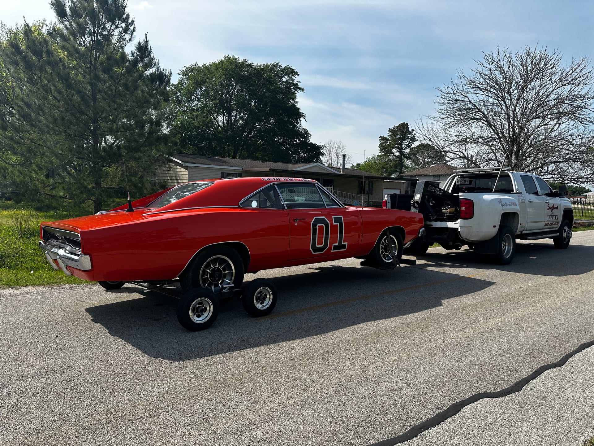 Orange Dodge Charger General Lee on our flatbed — Smith Towing flatbed transport