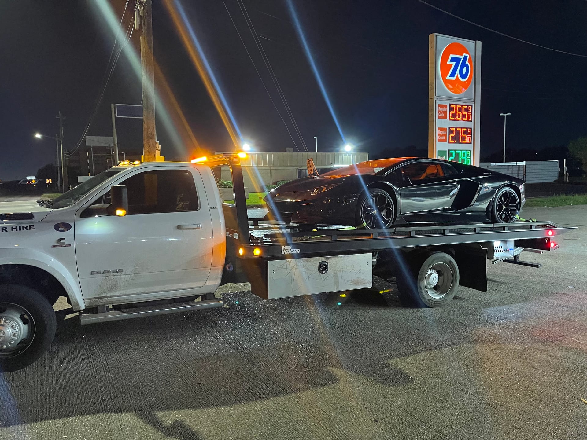 Lamborghini Aventador on our flatbed at night — specialty transport