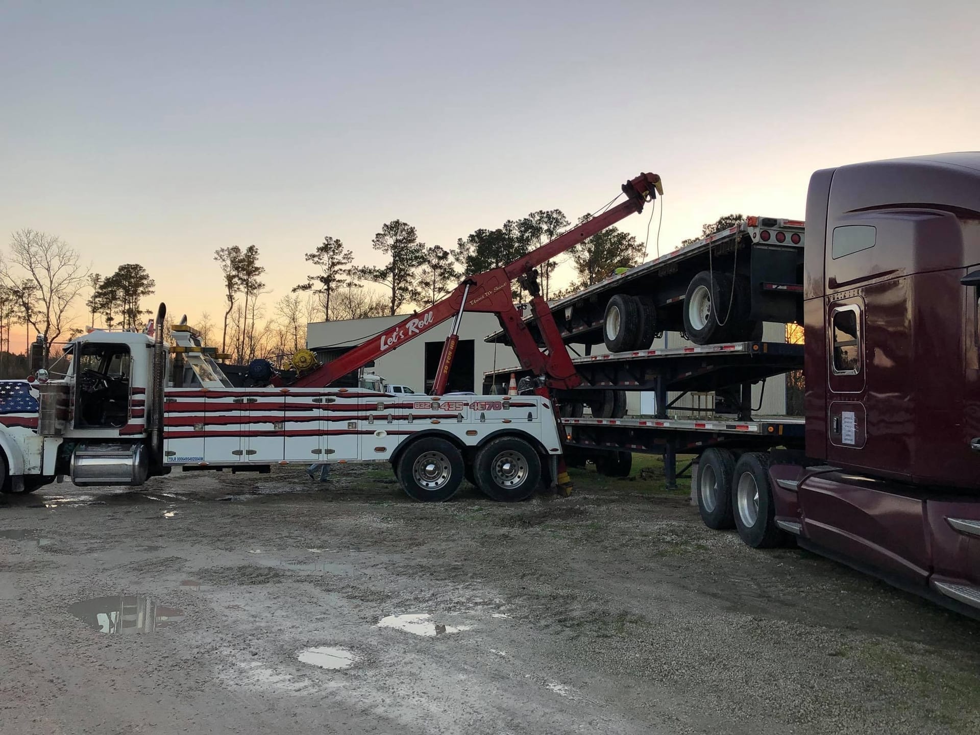 Smith Towing heavy wrecker near Dayton, TX at sunset